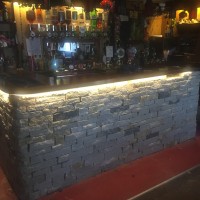 Finished stone clad bar, Swanage